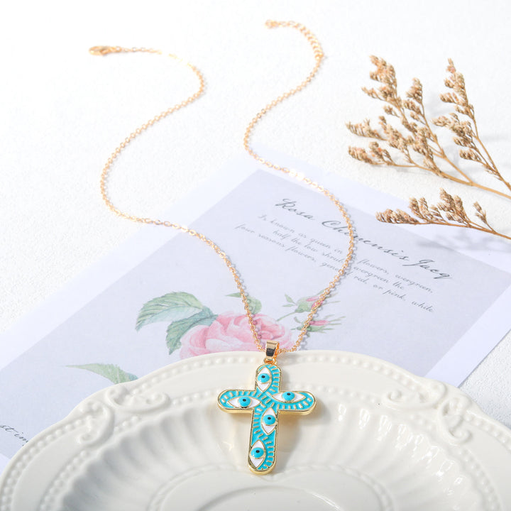 Collier Croix Mauvais Œil Olivenorma « Nous sommes protégés »