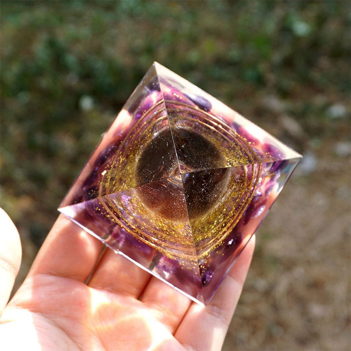 Boule de quartz fumé Olivenorma avec pyramide d'orgone en améthyste