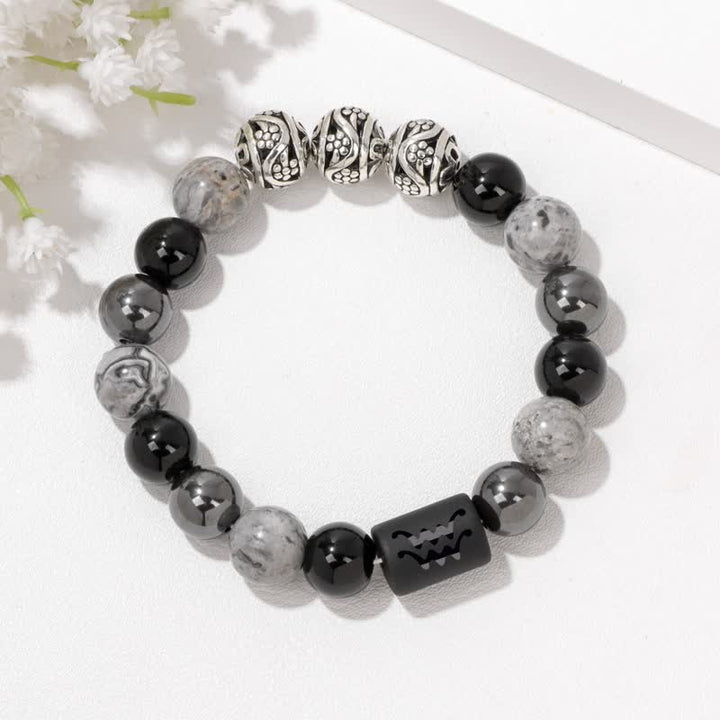 Bracelet en perles d'obsidienne, de jaspe gris et d'hématite avec signe du zodiaque Olivenorma