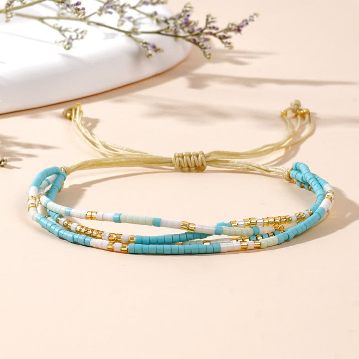 Bracelet de plage tressé en perles de riz bleu et blanc Olivenorma