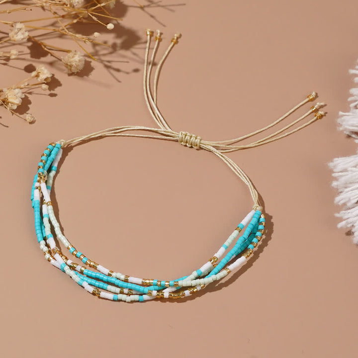 Bracelet de plage tressé en perles de riz bleu et blanc Olivenorma