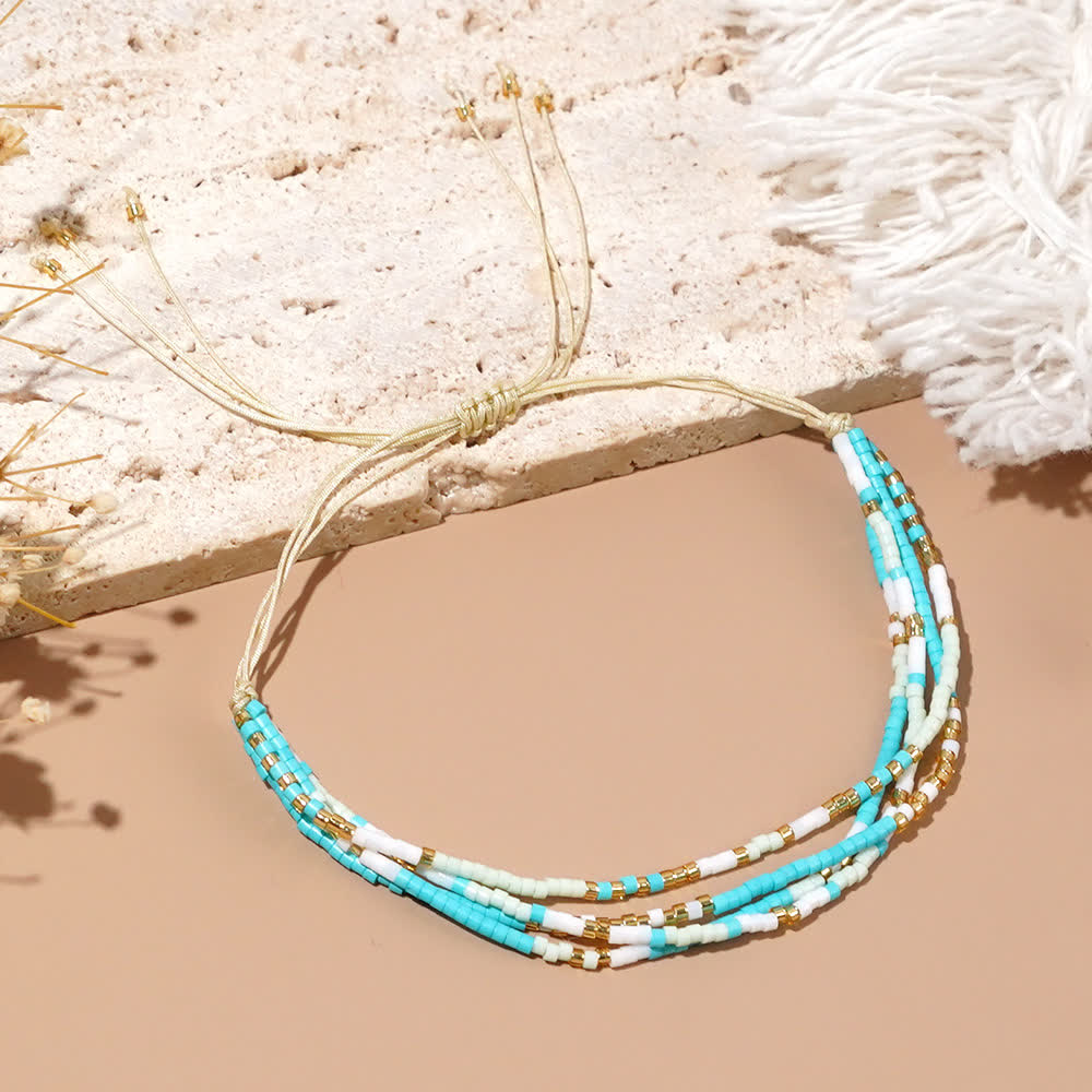 Bracelet de plage tressé en perles de riz bleu et blanc Olivenorma