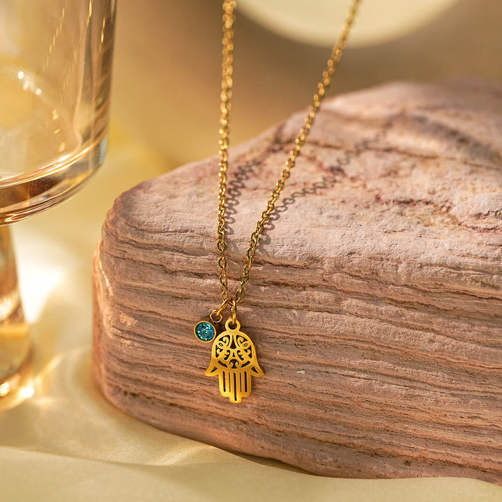 Collier à breloques Olivenorma avec croix aigue-marine et symbole du mauvais œil Hamsa