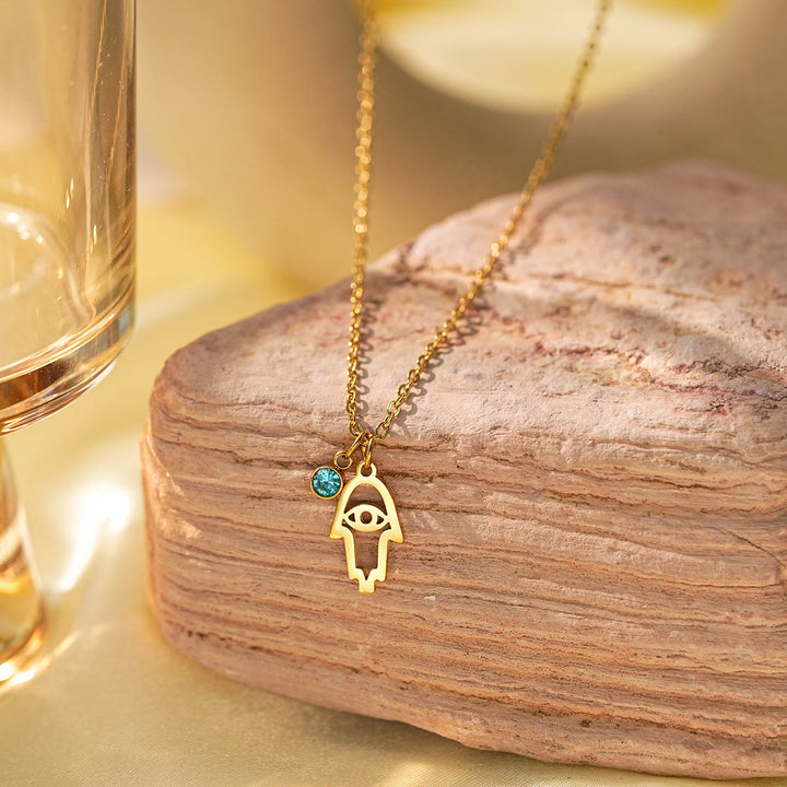 Collier à breloques Olivenorma avec croix aigue-marine et symbole du mauvais œil Hamsa