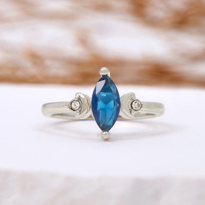 Bague Olivenorma en topaze bleue taille marquise et zircon blanc