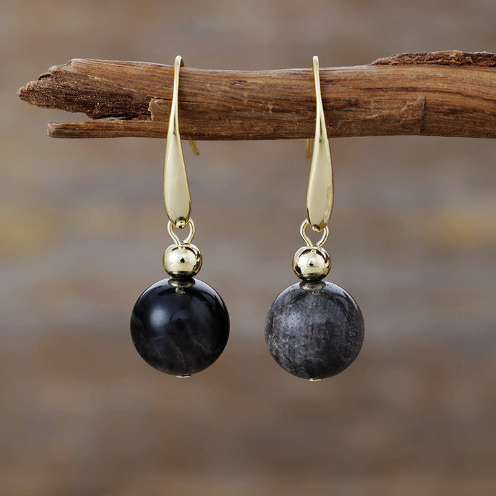 Boucles d'oreilles pendantes en boule de cristal naturel Olivenorma