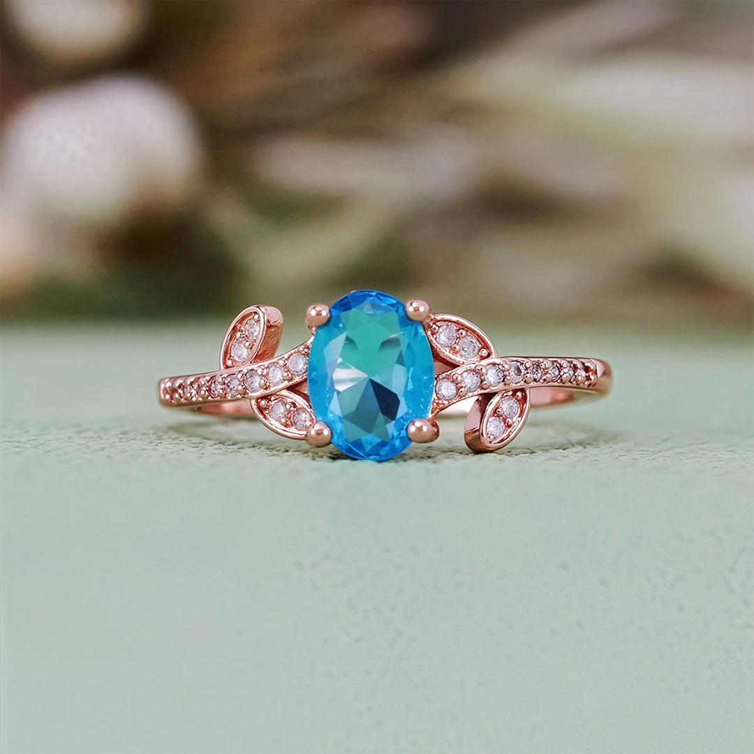 Bague Olivenorma avec topaze bleue taille ovale et feuille enveloppée