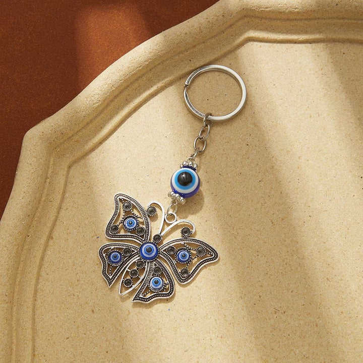 Porte-clés créatif Olivenorma avec mauvais œil bleu et détails animaux/plantes - Papillon-2 - image 6