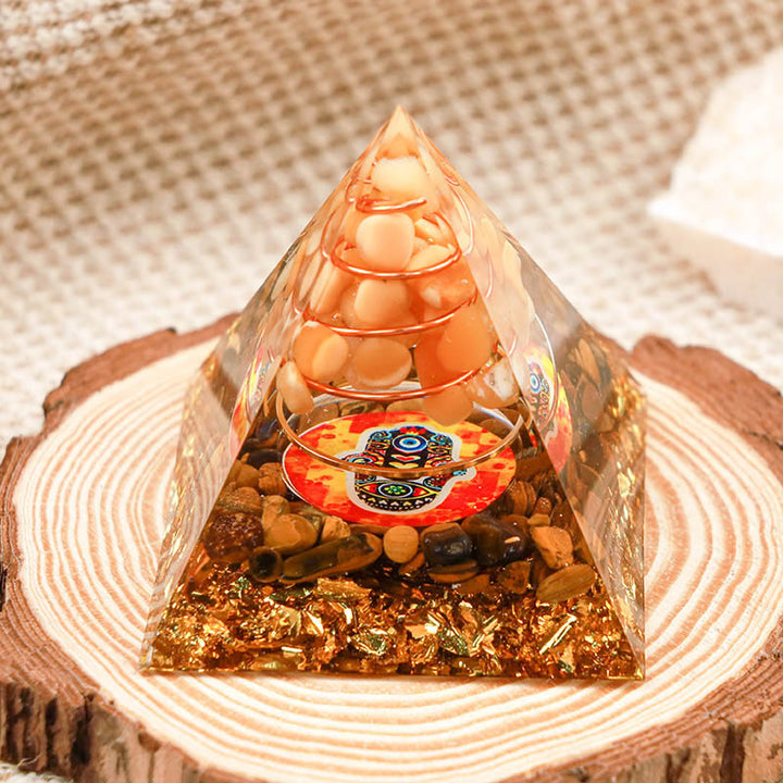 Pierre de soleil Olivenorma avec œil de tigre Pyramide Orgone Hamsa