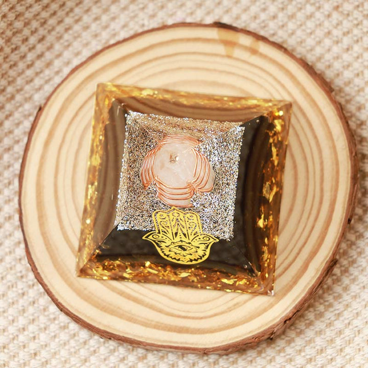 Cristal transparent Olivenorma avec pyramide orgonite Hamsa en obsidienne