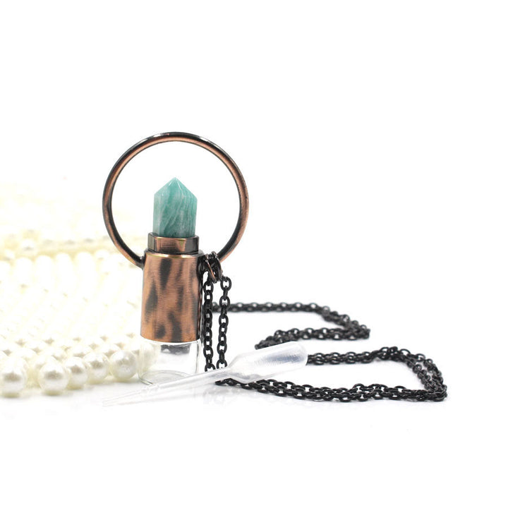 Pendentif bouteille de parfum en cristal naturel prismatique Olivenorma