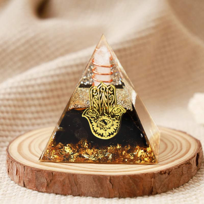Cristal transparent Olivenorma avec pyramide orgonite Hamsa en obsidienne