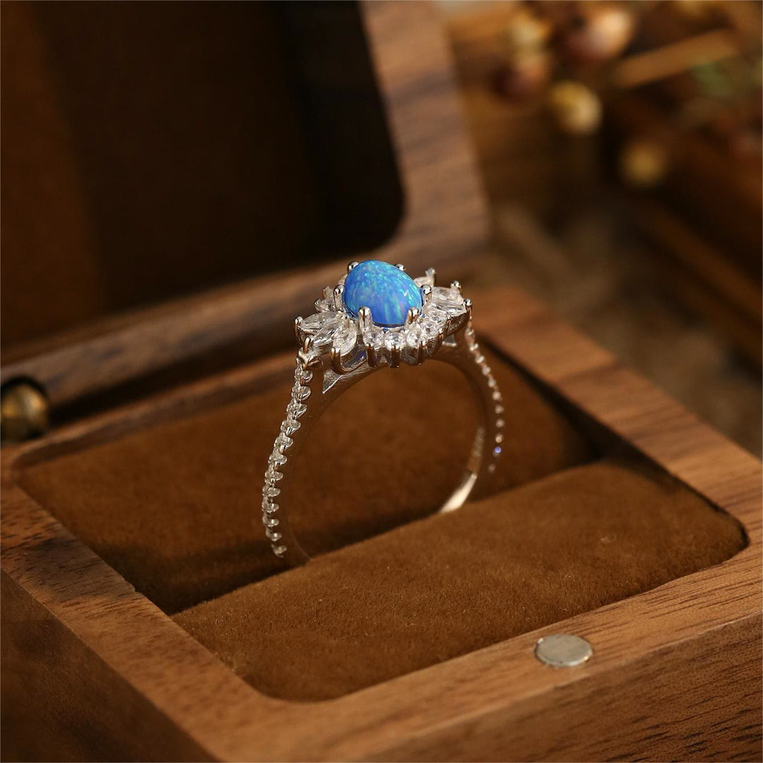 Bague en argent 925 avec motif tournesol et opale blanche et bleue Olivenorma