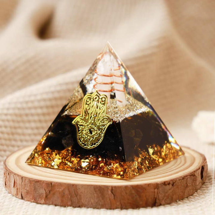 Cristal transparent Olivenorma avec pyramide orgonite Hamsa en obsidienne