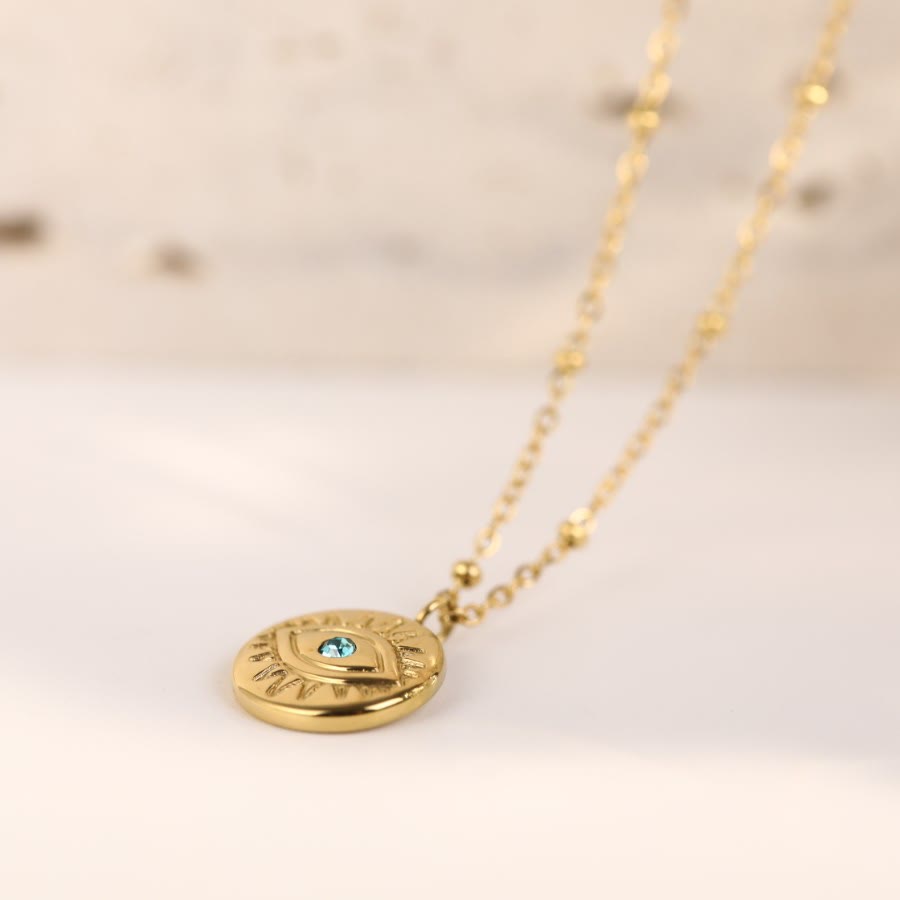 Collier Olivenorma en acier titane 316L avec topaze bleue et mauvais œil 