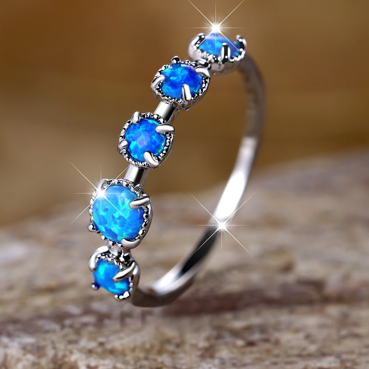 Bague Olivenorma à cinq motifs simples en opale bleue et blanche