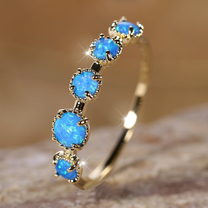 Bague Olivenorma à cinq motifs simples en opale bleue et blanche