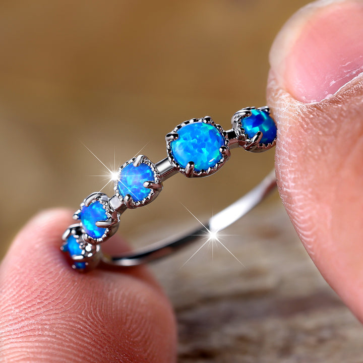 Bague Olivenorma à cinq motifs simples en opale bleue et blanche