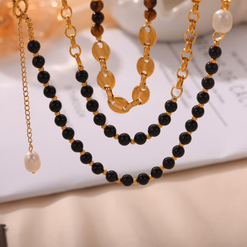 Collier en acier titane et perles d'eau douce en obsidienne œil de tigre Olivenorma 