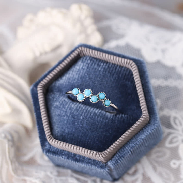 Bague de couple créative ronde à quatre griffes en turquoise Olivenorma