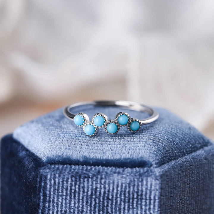 Bague de couple créative ronde à quatre griffes en turquoise Olivenorma