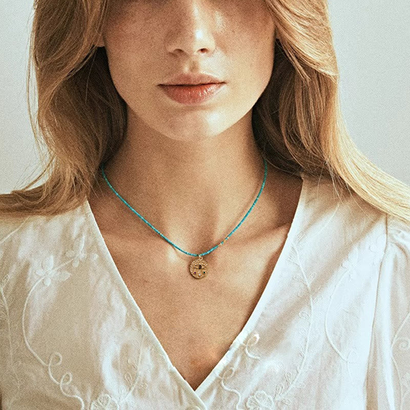 Collier de perles turquoise avec breloque mauvais œil Olivenorma