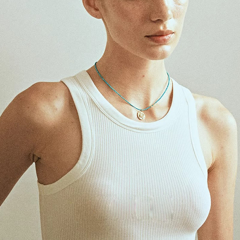 Collier de perles turquoise avec breloque mauvais œil Olivenorma