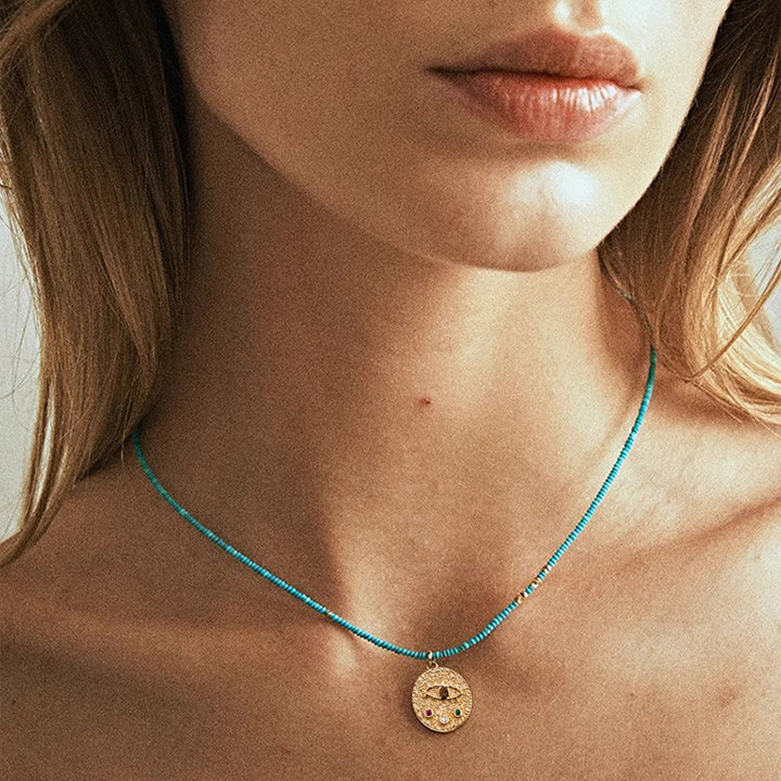 Collier de perles turquoise avec breloque mauvais œil Olivenorma