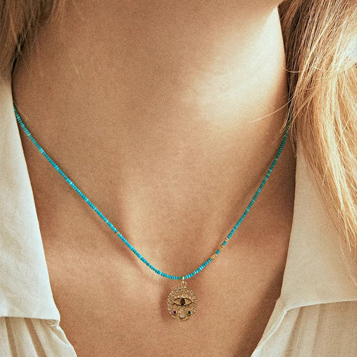 Collier de perles turquoise avec breloque mauvais œil Olivenorma