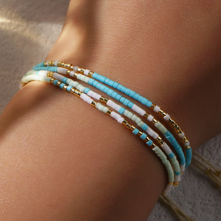 Bracelet de plage tressé en perles de riz bleu et blanc Olivenorma