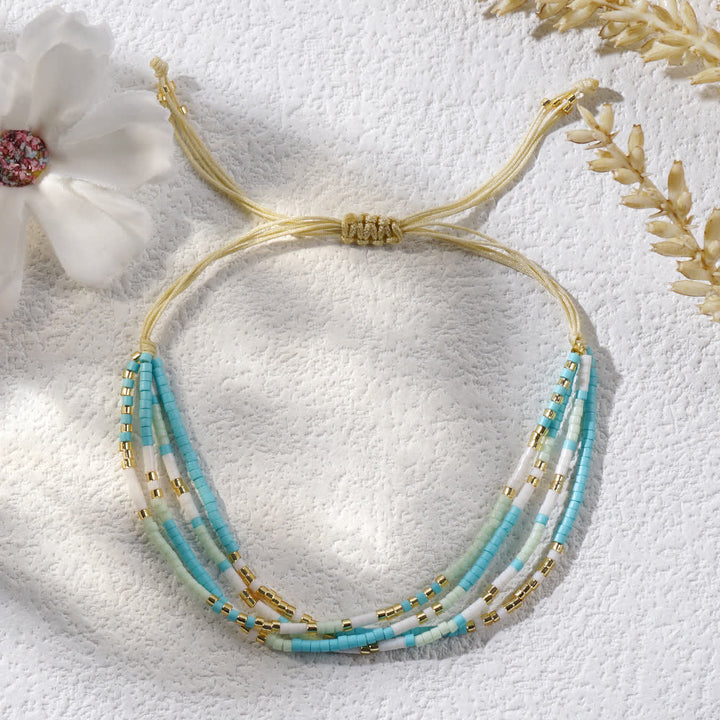 Bracelet de plage tressé en perles de riz bleu et blanc Olivenorma