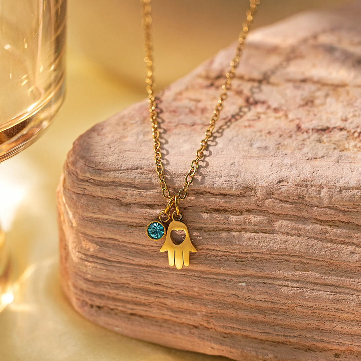 Collier à breloques Olivenorma avec croix aigue-marine et symbole du mauvais œil Hamsa