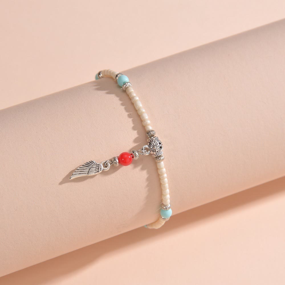 Bracelet de cheville avec pendentif plume en métal et perles turquoise blanches Olivenorma