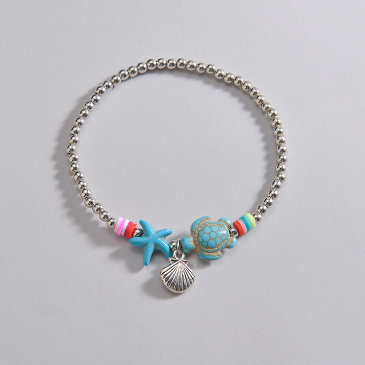Pendentif de cheville en perles de bois et coquillages en métal turquoise Olivenorma