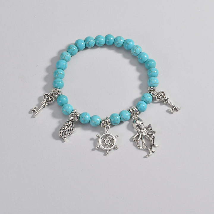 Pendentif de cheville en métal perlé turquoise Olivenorma représentant la vie marine