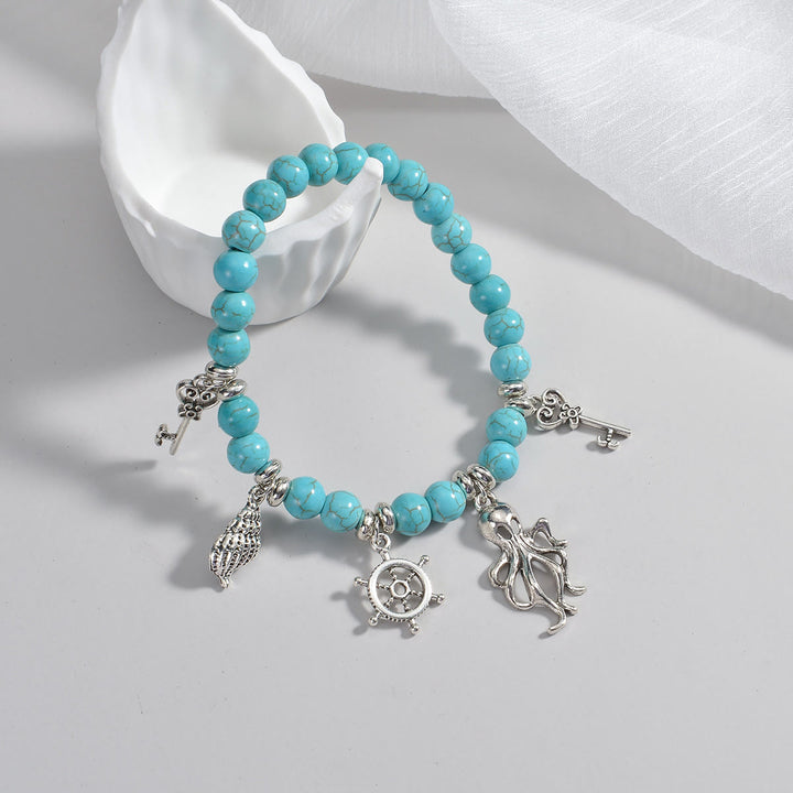 Pendentif de cheville en métal perlé turquoise Olivenorma représentant la vie marine
