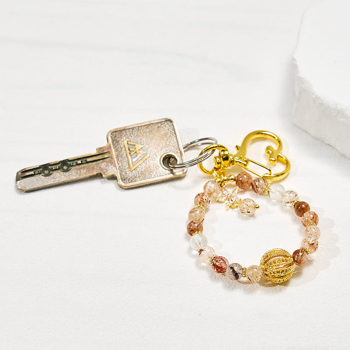 Porte-clés Olivenorma en quartz rutile doré et dragonne pour téléphone en cristal - image 1