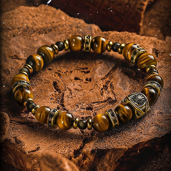 Bracelet Olivenorma en œil de tigre et obsidienne dorée avec symbole solaire gravé - image 1