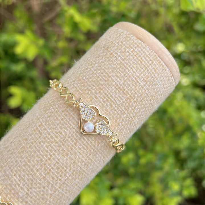 Bracelet Olivenorma en cuivre avec pendentif œil protecteur et porte-bonheur - Breloque perle en forme de cœur et d'aile - image 6