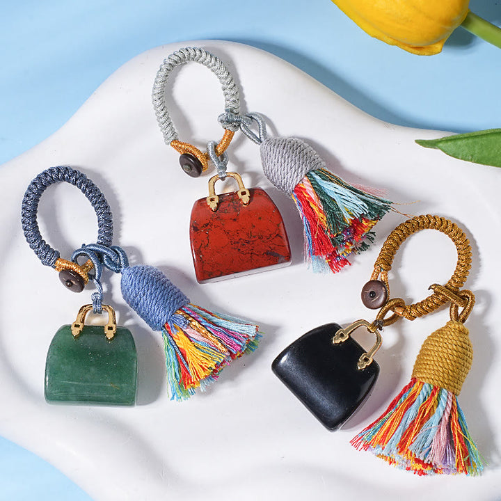 Porte-clés Olivenorma en cristal naturel, en forme de sac à main, avec pompon tressé et symbole de prospérité - image 0