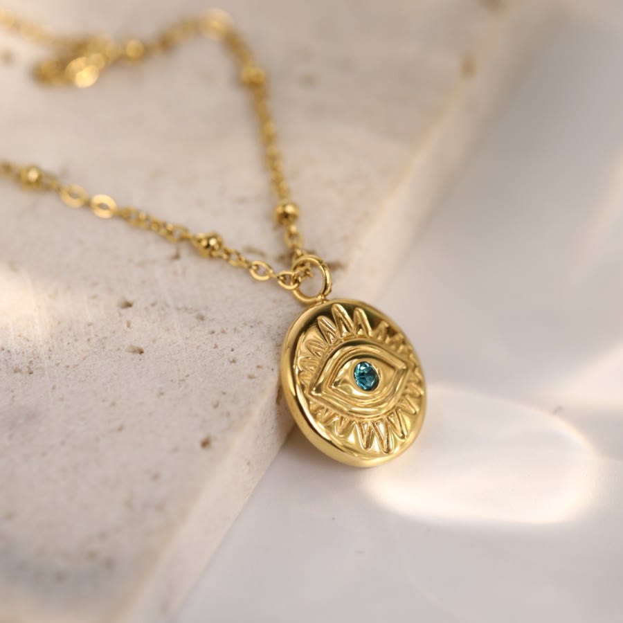 Collier Olivenorma en acier titane 316L avec topaze bleue et mauvais œil 