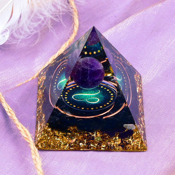 Sphère d'améthyste Olivenorma avec pyramide d'orgone du zodiaque Lion en obsidienne