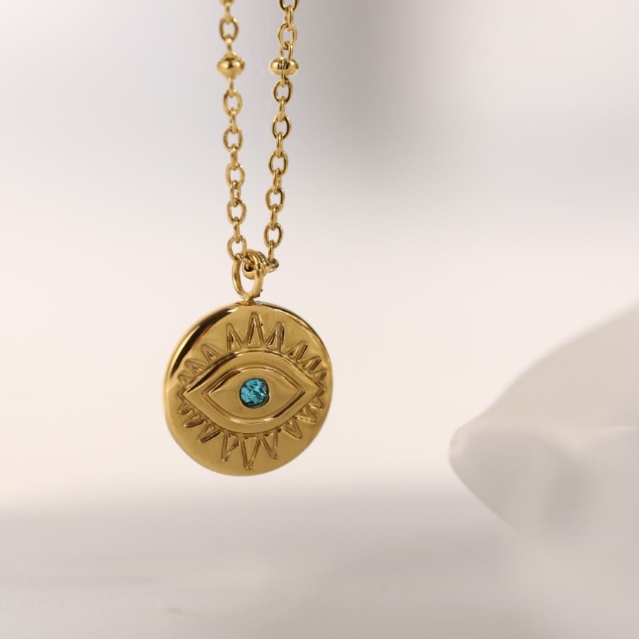 Collier Olivenorma en acier titane 316L avec topaze bleue et mauvais œil 