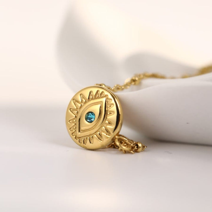 Collier Olivenorma en acier titane 316L avec topaze bleue et mauvais œil 
