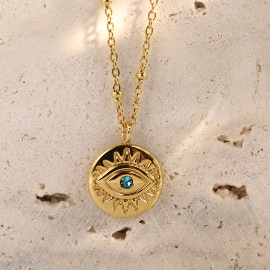 Collier Olivenorma en acier titane 316L avec topaze bleue et mauvais œil 