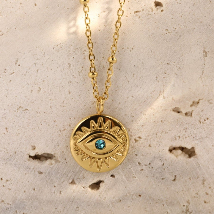 Collier Olivenorma en acier titane 316L avec topaze bleue et mauvais œil 