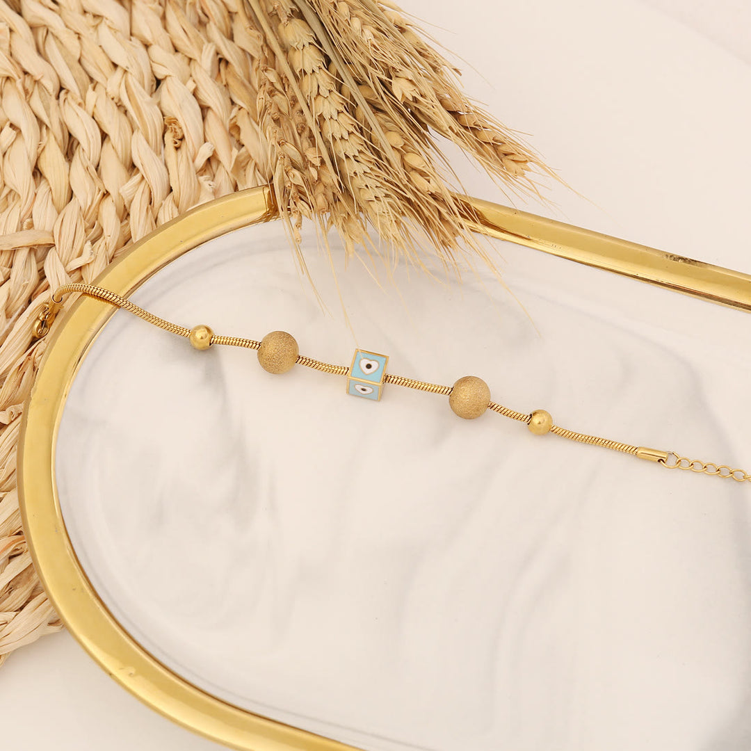 Bracelet porte-bonheur Olivenorma en époxy avec topaze bleue et trèfle mauvais œil