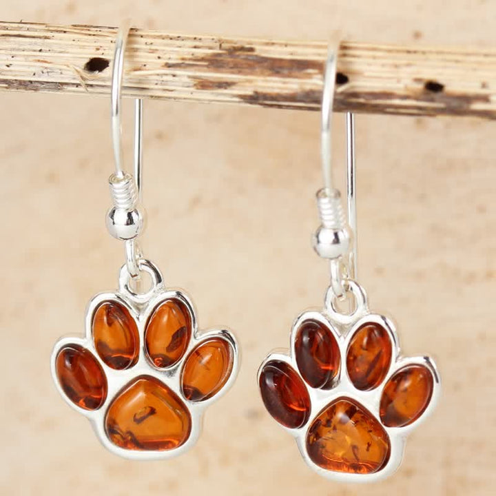 Boucles d'oreilles pendantes en ambre avec empreinte de patte de chien
