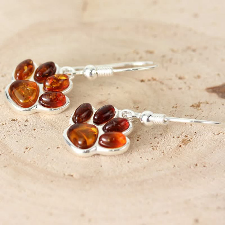 Boucles d'oreilles pendantes en ambre avec empreinte de patte de chien