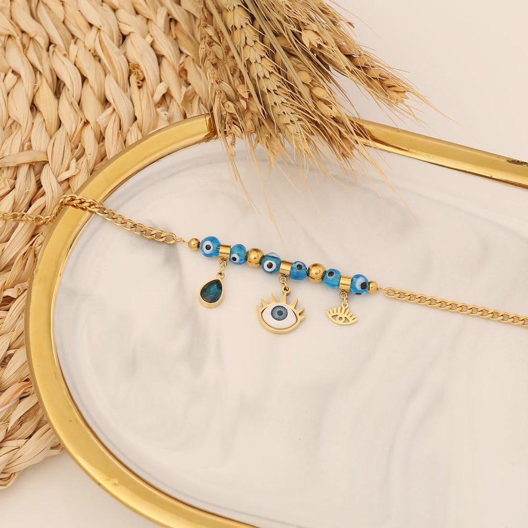 Bracelet porte-bonheur Olivenorma en époxy avec topaze bleue et trèfle mauvais œil